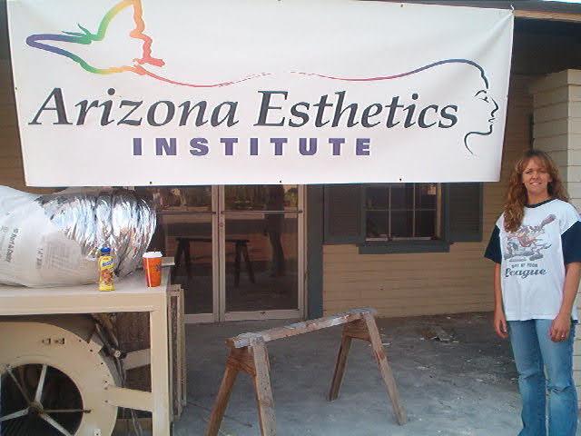 Christie Stephenson standing in front of Arizona Esthetics Institute sign during facility build-out