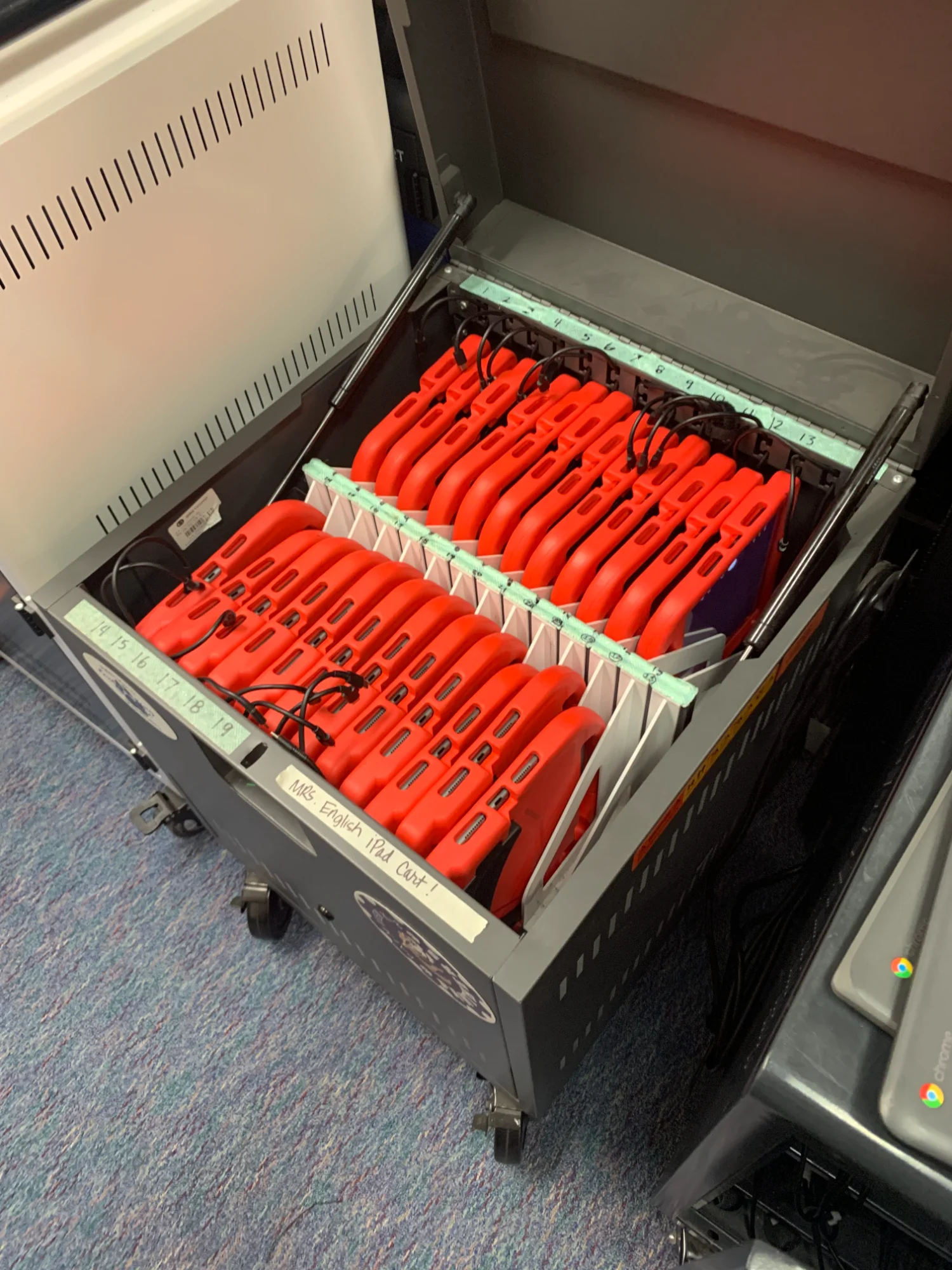 iPad cart with numbered devices in protective cases