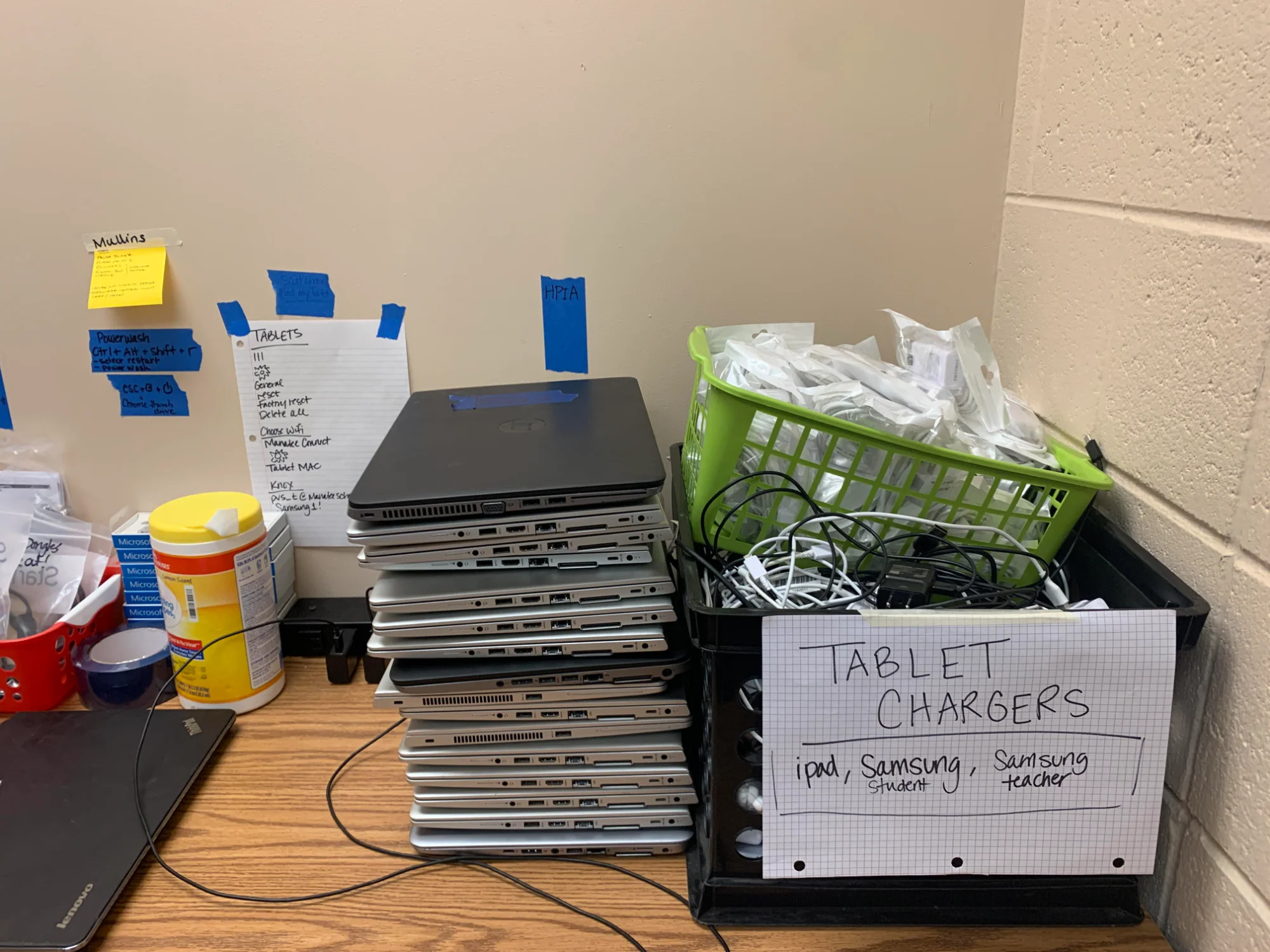 Workstation with laptops and handwritten quick reference guides